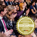 An audience clapping and the shortlisted badge ofr the Charity Governance Awards 2025.