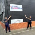 Two of the physio team – Christina and Shaz – outside the Chilterns Neuro Centre showing off the new sign with the new name and logo.