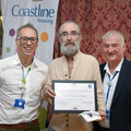 Kimberley Croft accepts his Good Neighbour Award from Allister Young (left) and Steve Harrison