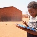 Malawian girl using onebillion software on a tablet