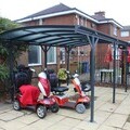 Users of the Bishop King Centre in Grimsby place their scooters under the new shelter