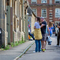 Visitors enjoy the Lacock Scarecrow Trail, pausing to admire one of the creative entries displayed along the historic village streets.