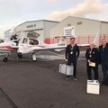 Civil Air Support Pilot handing over 20 litres of breastmilk to Blood Bikers at Newcastle