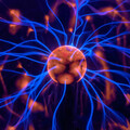 Blue and orange plasma ball with live currents