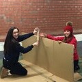 Fundraisers putting together their cardboard dens at YMCA Sleep Easy