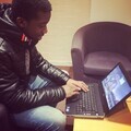 Homeless youth using laptops in accommodation services