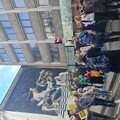 A group stops at the old city walls, below a huge piece of street art, at the Bristol Walk Fest launch night walk