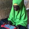 Tanzanian girl using onebillion software on a tablet