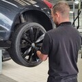 Technician checking car tyres