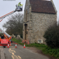 Burnham Norton Friary with cherry picker investigating the condition of the walls