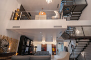 A striking view of Venue C’s contemporary open-plan living space, featuring soaring double-height ceilings.