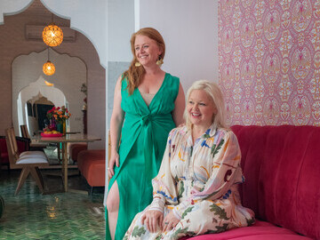 Owner Angela (couch) and Designer Claire