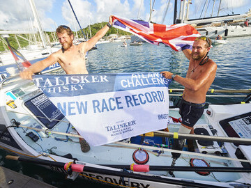 Sergeant Jordan Beecher and Captain Jon Armstrong celebrate rowing 3,000 nautical miles across the Atlantic in the Talisker Whiskey Atlantic Challenge