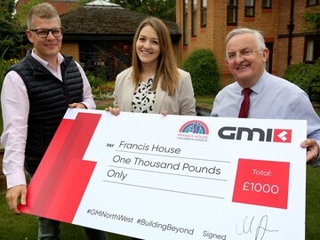 L-R Marc Banks, GMI’s divisional managing director donating £1,000 to Rachel Nasiri and David Ireland of Francis House.