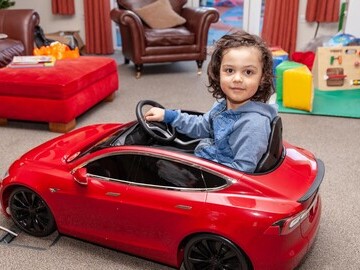 Orion (four) was the first of the young patients at the hospice to test drive the new RadioFlyer Tesla car, donated by Tesla Owners