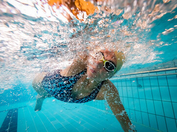 Underwater shot of woman swimming front crawl
