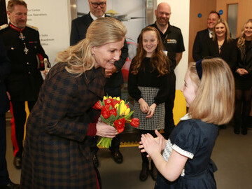 The Countess being presented with flowers from former airlifted patient Milli Smith
