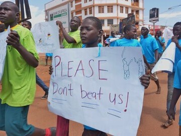 Homeless child shares sign with local community for international day for street children 3