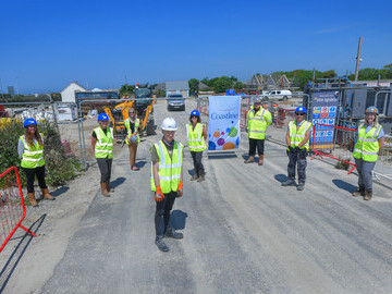 Ben stands front and centre outside the entrance to Coastline’s Quintrell Downs development 