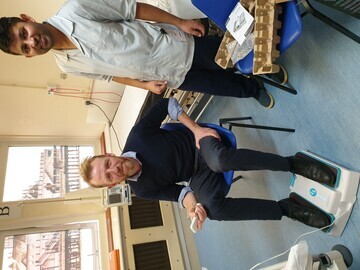 Dr Richard Simcock, Consultant & Ravikumar Pankhaniyar, Healthcare Assistant with one of the leg exercise machines