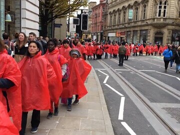 Women representing the women killed walk silently through the city centre