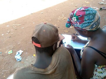 Female researcher completing data with a street connected child
