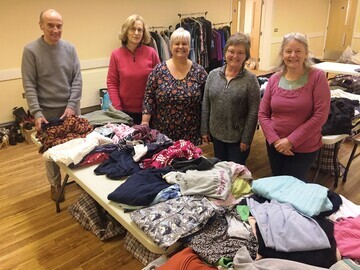 Accompanying Photos:  · Boxes of goods ready to go at Immaculate Conception, Southampton and  · Volunteers at St. Mary’s, Alton sorting warm clothes r