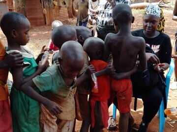 Children on the streets of Jinja  lining up to share their details with a research