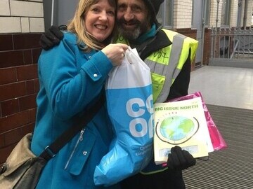 Big Issue North vendor Dave before lockdown began with a member of staff from the Co-Op branch by his pitch