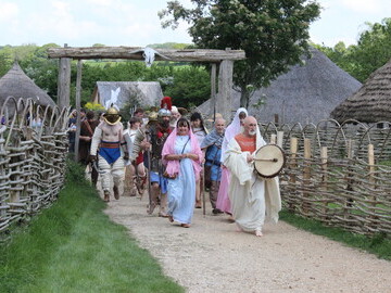 Gladiators parade through the Iron Age Village at Butser Ancient Farm