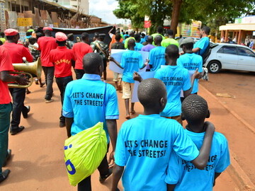 Homeless children marching through Jinja for the International Day for Street Children