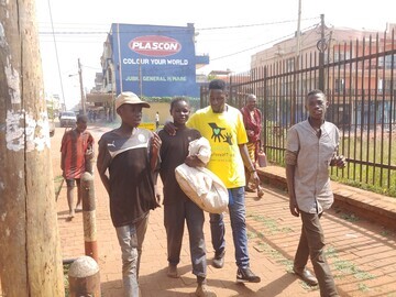 S.A.L.V.E. International staff member walking with children who are on the streets of Jinja