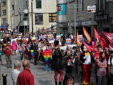 Welsh Pride Parade marching last year through Cardiff city centre.