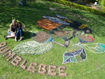 Natalie Peace and Donna Booth from Growth Activities with giant land-art Bilberry bumblebee
