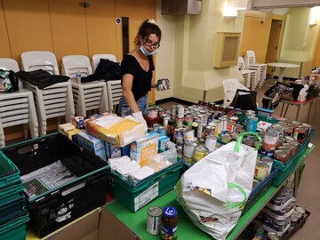 Volunteer sorting through donations of food