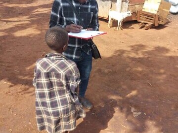Male researcher completing data gathering with a street connected child