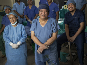 Dr Sanduk Ruit sand his team in a makeshift operating theatre