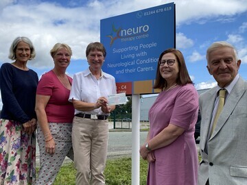 A £50,000 grant for expansion at the Neuro Therapy Centre in Saltney is handed over by The Ursula Keyes Trust, outside the new facilities.