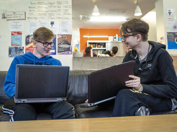 Homeless youth using laptops, inclusive society