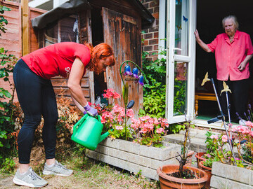 A GoodGymer supports an older person with gardening