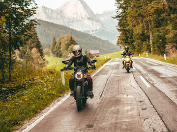 Two of the co-founders on their bikes riding through the Austrian Alps