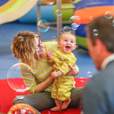 happy baby watching the bubbles in a Gymboree Play & Music class
