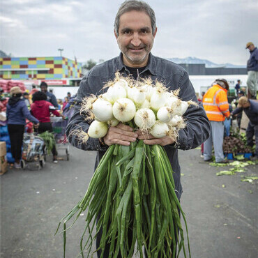 Chef Emilio Deik holding fresh produce.