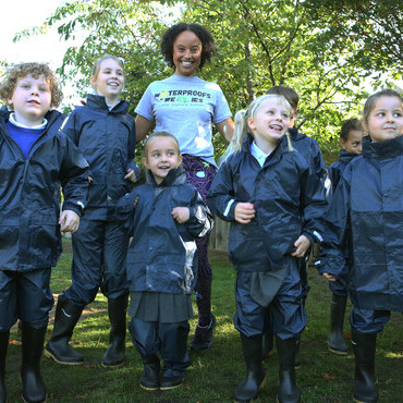 Gemma Hunt helps children unpack their new waterproof clothing and wellies during The Outdoor Guide Foundation’s  school visit.