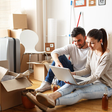 young couple unpacking boxes