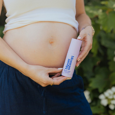 One Hot Mama holding beside belly